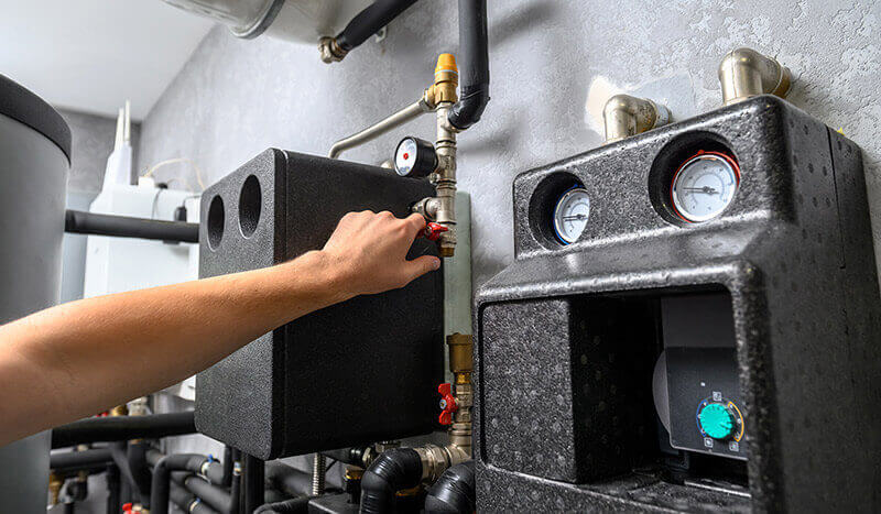 boiler-room-system-maintenance commercial boiler services working on an appliance